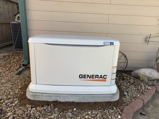 Generac generator on a pad with landscaping rock
